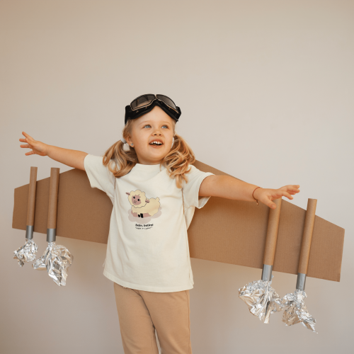 front-view-girl-playing-with-cardboard-wings-2